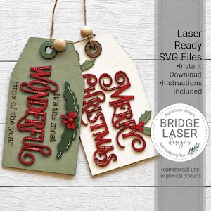 May include: Two wooden gift tags with twine and wooden beads. One olive green tag features the red text It's the most wonderful time of the year and a green holly sprig. The white tag features red Merry Christmas text and a green holly sprig.