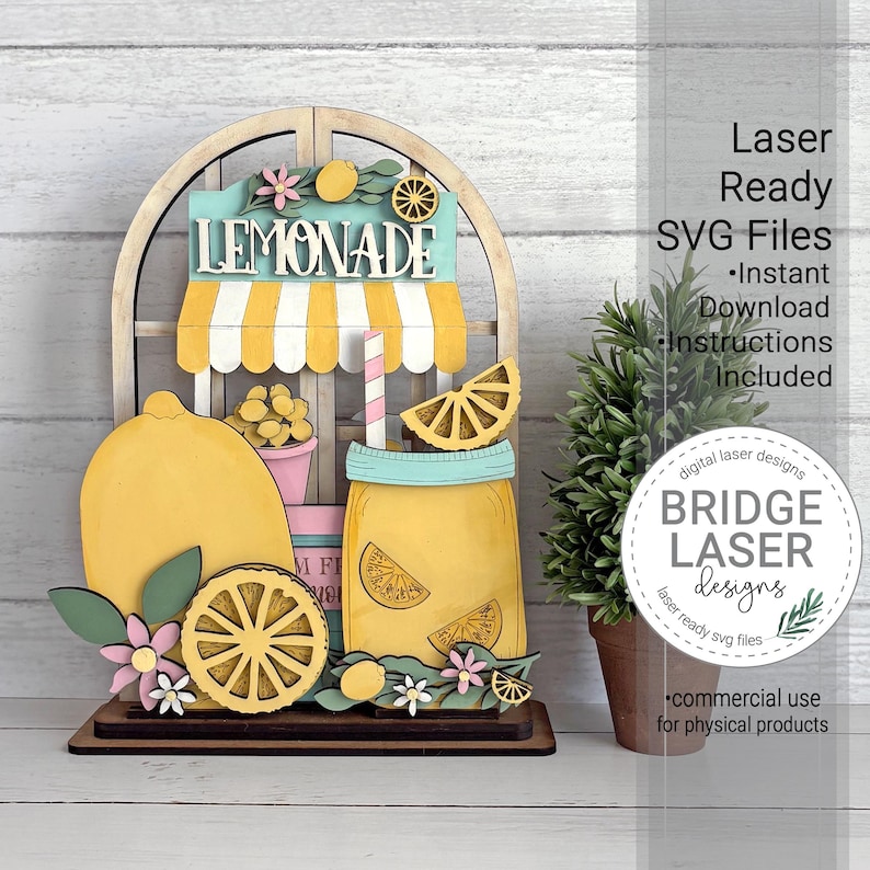May include: A wooden lemonade stand decoration with a yellow and white striped awning, a large lemon, and a mason jar of lemonade. The sign reads "LEMONADE". Includes flowers and lemon slices. Laser Ready SVG Files.