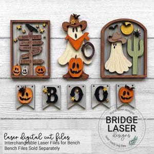 May include: A set of laser-cut wooden Halloween decorations including a signpost with text, a ghost in a cowboy hat with a pumpkin, a ghost with a cactus, and five banner pieces spelling BOO with pumpkins and stars in orange, black, and tan.