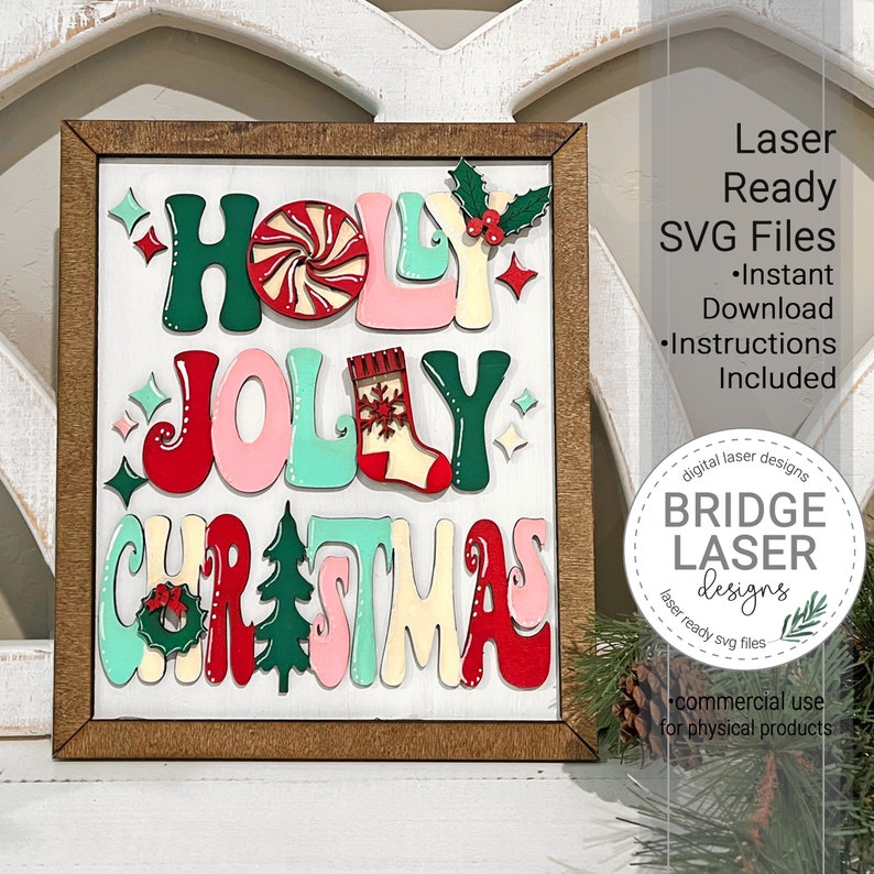 May include: A rectangular wooden sign featuring the text HOLY JOLLY CHRISTMAS in layered, colorful letters. The design includes a peppermint candy, a stocking, a wreath, and a pine tree. The sign is framed in dark wood with a white background.