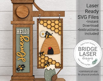 May include: A laser-cut wooden sign featuring a vertical post with the text Hello Honey and a hanging rectangular panel displaying a beehive, honeycomb patterns, a daisy, and bees. A small honey pot with a dipper is attached to the base of the sign.