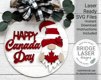 May include: A red and white gnome holding a red maple leaf with the words "Happy Canada Day" in red letters on a white round wooden sign.