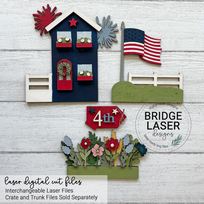 May include: A set of laser-cut wooden pieces for a patriotic display, including a dark blue house with a red door and wreath, a US flag on a pole, a red sign with the text 4th, and a base featuring various colorful flowers and greenery.