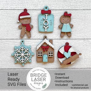 Pode incluir: Uma coleção de enfeites de Natal cortados a laser em várias formas, incluindo bonecos de gengibre, um floco de neve e uma bengala de doces. Os enfeites apresentam cores vermelhas, azuis e marrons. A palavra "JOY" é exibida em um enfeite. A imagem também inclui o texto "Laser Ready SVG Files".