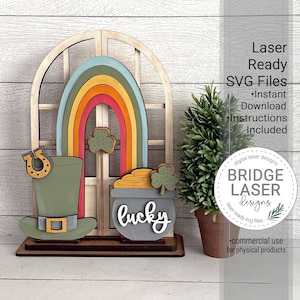 May include: A wooden St. Patrick's Day decoration featuring a rainbow, pot of gold, leprechaun hat, and horseshoe. The word "lucky" is written on the pot of gold. The text "Laser Ready SVG Files" is also visible.