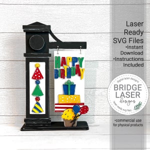 Puede incluir: Un letrero de madera negro con una pancarta blanca que dice "Feliz cumplea&ntilde;os" en letras de colores. El letrero est&aacute; decorado con una magdalena, regalos y sombreros de fiesta. El letrero est&aacute; cortado con l&aacute;ser y listo para ensamblar.