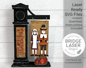 May include: A laser-cut wooden Thanksgiving sign with a black and white "Thankful" sign, a pilgrim couple, and pumpkins. The sign is ready to be assembled and comes with instructions. The sign is designed by Bridge Laser Designs.