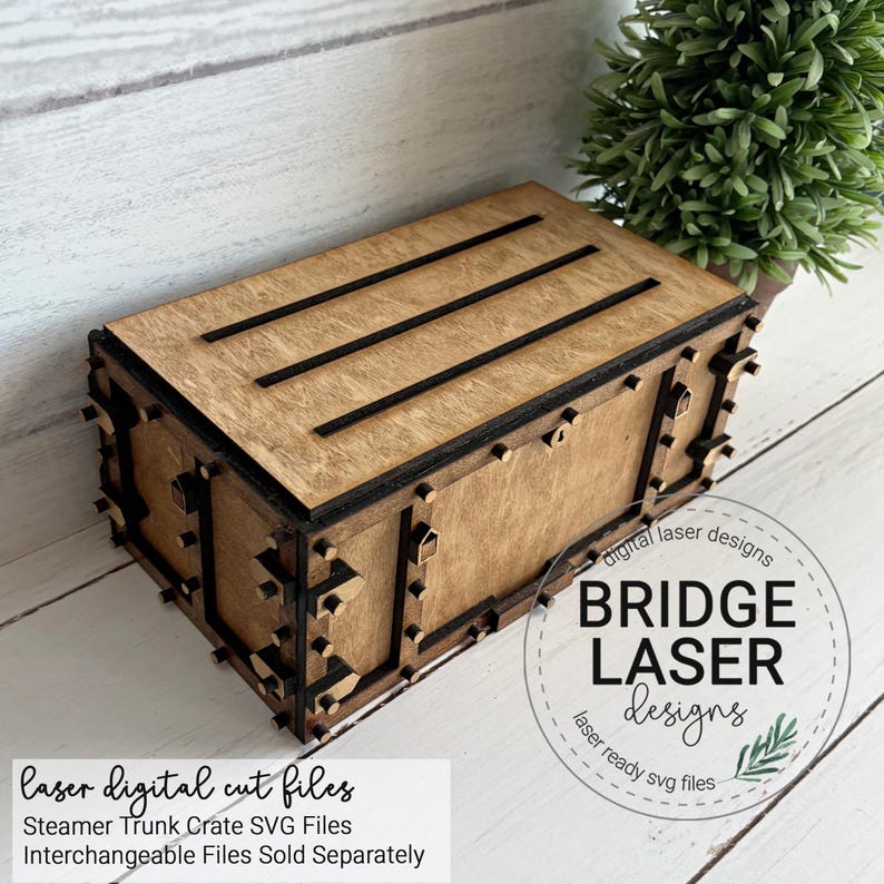 May include: A rectangular wooden box with a lid featuring three horizontal black slats. The box has dark brown edges and decorative small wooden accents along the sides. Text on the image reads: Bridge Laser Designs, laser digital cut files, Steamer Trunk Crate SVG Files, Interchangeable Files Sold Separately.