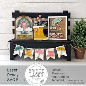 May include: A set of laser cut SVG files for a spring-themed craft project. The design includes a rainbow, a heart, clouds, the words "hello spring", a pair of rain boots, a flower pot with flowers, and a sign that says "April showers bring May flowers".