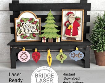 May include: A black wooden bench displays Christmas decorations. These include a sign with "Merry Christmas", a green tree, and a Santa Claus figure. Below, a garland holds various ornaments. The image also includes the text "Laser Ready SVG Files".