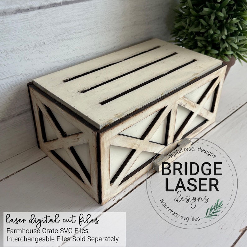 May include: A rectangular wooden crate with a distressed off-white finish and dark edges. The sides feature a cross-brace design, and the top has three horizontal slats. Text on the image reads: digital laser designs BRIDGE LASER designs.