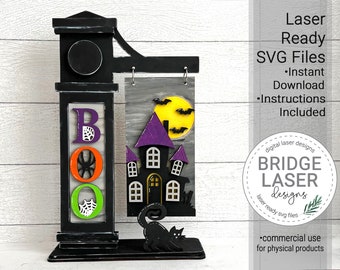 May include: A black wooden BOO sign with a black cat and a haunted house with a purple roof and a yellow moon. The sign is laser cut and ready to assemble. The sign is for commercial use for physical products.