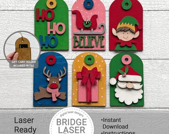 May include: A selection of colourful wooden Christmas gift tags. Each tag features a different festive design, including Santa Claus, an elf, a reindeer, and the words "HO HO HO" and "BELIEVE". The tags are laser-ready SVG files.