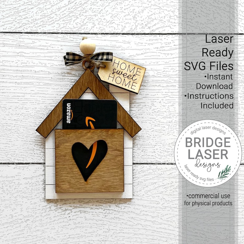 May include: Laser cut wooden house shaped gift holder with a heart cutout and a gift card slot. The house is decorated with a black and white checkered ribbon and a tag that says "Home Sweet Home".