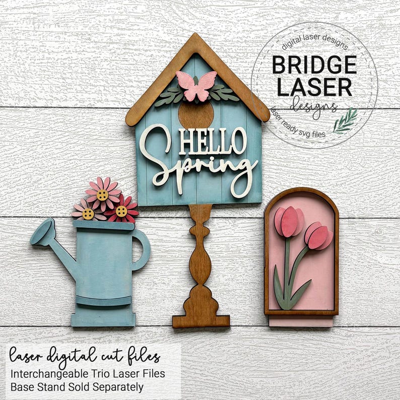 Puede incluir: Un tr&iacute;o de decoraciones de madera cortadas con l&aacute;ser con tem&aacute;tica primaveral. Incluye una casita para p&aacute;jaros azul con el texto "HELLO SPRING", una regadera con flores rosas y un dise&ntilde;o de tulipanes enmarcados. La casita tiene un acento de mariposa.