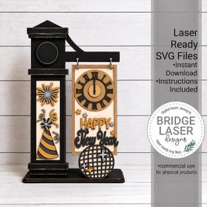 May include: A laser-cut wooden New Year decoration featuring a black clock tower structure with a hanging rectangular sign. The sign displays a clock face, the text Happy New Year, a party hat, fireworks, and a disco ball in black, gold, and silver.