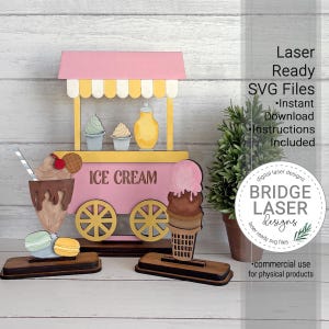 May include: A wooden ice cream cart with pink, yellow, and brown accents. The cart features ice cream cones, sundaes, and macarons. The text "ICE CREAM" is displayed on the cart. The image also includes the text "Laser Ready SVG Files".