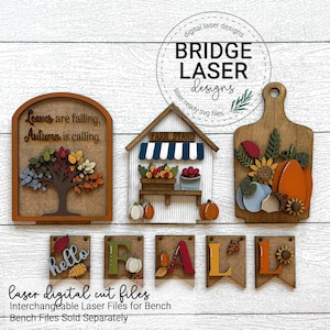 May include: Wooden fall-themed laser cut files. Includes a sign with a tree and the text "Leaves are falling, Autumn is calling", a farm stand, a cutting board with pumpkins and sunflowers, and the word "FALL".