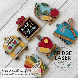 May include: A set of six school-themed wooden ornaments featuring a globe with a pencil and apple, a chalkboard with the text READY SET LEARN, a blue notebook with scissors and a ruler, a yellow school bus, an apple with a pencil, and a box of crayons.