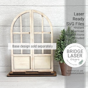 May include: A wooden arched window frame with a dark brown base. The window is divided into four sections with a light beige finish. Text on the image reads "Laser Ready SVG Files" and "Base design sold separately". A small potted plant is to the right.