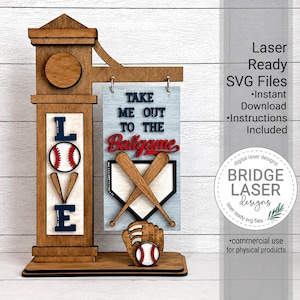 May include: A wooden laser-cut baseball-themed sign featuring the word LOVE with a baseball and bats, and a hanging plaque that reads TAKE ME OUT TO THE BALLGAME with crossed bats, a home plate, and a baseball glove with a baseball.