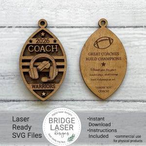 May include: Two oval-shaped wooden ornaments with a football-like silhouette. The left ornament features the text 2026, COACH, and WARRIORS with a headset and whistle graphic. The right ornament displays a football, the text GREAT COACHES BUILD CHAMPIONS, and a thank you message.