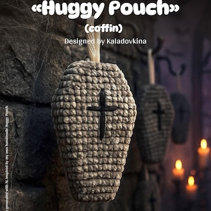 May include: A crocheted coffin-shaped pouch with a black cross, part of a crochet pattern. The text "Huggy Pouch" and "(coffin)" are visible. Designed by Kaladovkina. The pouch is a light brown color and is hanging on a stone wall.