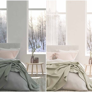 May include: A bedroom with a bed made with a white duvet, a light green throw blanket, and two pink pillows. The bed is next to a wooden side table with a vase of white flowers and two decorative jars. The room has large windows with white curtains and a view of a snowy forest.