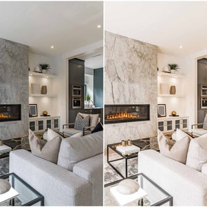 May include: A modern living room with a fireplace, a large white couch, and a gray stone wall. The fireplace has a glass front and a fire burning inside. The couch has a few pillows on it and is facing the fireplace. There is a coffee table in front of the couch.