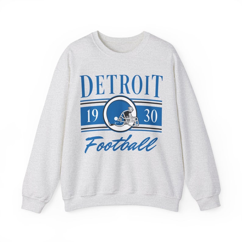 Light ash gray sweatshirt with a retro vintage Detroit Football design on the front, including the founding date (1930) of the Detroit Lions, and a seating chart layout design of Ford Field across the back.