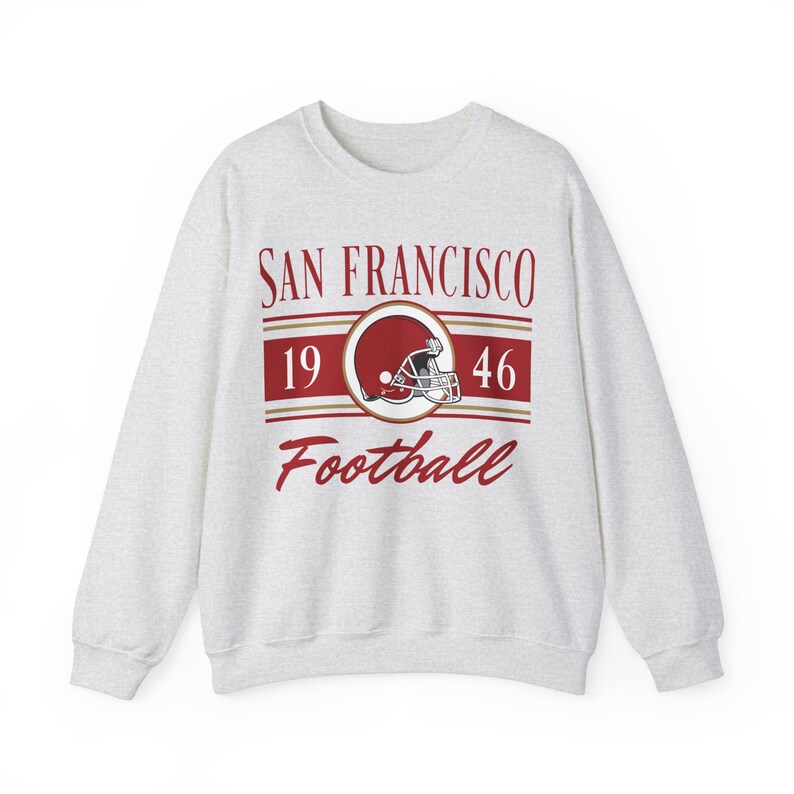 Light ash gray sweatshirt with a retro vintage San Francisco Football design on the front, including the founding date (1946) of the San Francisco 49ers, and a seating chart layout design of Levi's Stadium across the back.