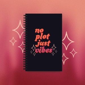 May include: A black spiral notebook with the text "no plot just vibes" in orange and pink lettering. The notebook is surrounded by white stars.