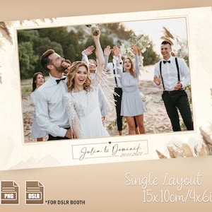 Op de afbeelding: Een sjabloon voor een fotohokje voor een bruiloft met één fotolijst. De lijst heeft een witte achtergrond met een gouden rand en een aquarelontwerp van gedroogd pampasgras in de hoeken. De tekst "Joba & Dominik - 20.01.2023" staat in een cursief lettertype onderaan de lijst. Het sjabloon is ontworpen voor een foto van 10x15 cm.