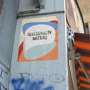 May include: A poster with a blue, white, and orange abstract design. The poster has the text "ACCESSIBILITY MATTERS" in a white speech bubble.