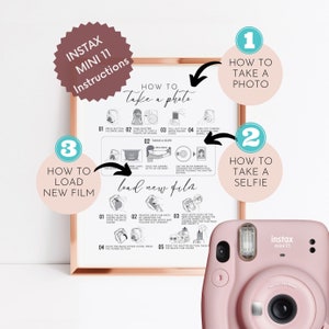 May include: A pink Instax Mini 11 camera next to a framed instructional guide. The guide, with a rose gold frame, details how to take photos, selfies, and load film. The guide includes the text "INSTAX MINI 11 Instructions".
