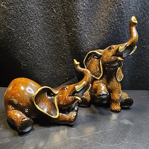 TWO Vintage Playful Baby Elephant Figurines | Ceramic | Brown with Gold | Trunk Up | MidCentury Modern