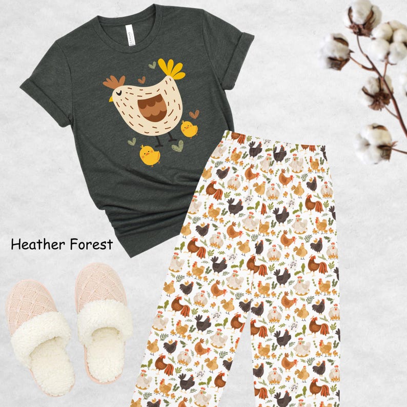 May include: A heather forest green t-shirt with a cartoon illustration of a brown hen and chicks. The t-shirt is paired with white pajama pants featuring a repeating pattern of brown, white, and black chickens.