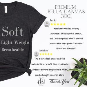 May include: A dark grey Bella Canvas 3001 t-shirt with a V-neck. The shirt is soft, lightweight, and breathable. The text "Soft", "Light Weight", and "Breatheable" is printed on the shirt. The shirt is shown on a white background with customer reviews.