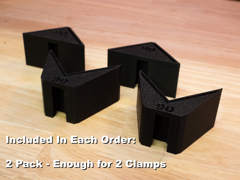 May include: Four black plastic corner clamps, each marked with "90", are arranged on a wooden surface. The text "Included In Each Order: 2 Pack - Enough for 2 Clamps" is visible below the clamps.