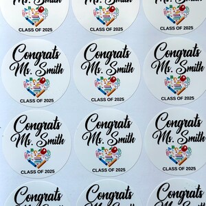Puede incluir: Nueve pegatinas redondas blancas con texto negro que dice "Felicidades Sra. Smith Clase de 2025". Cada pegatina tiene una ilustración colorida de útiles escolares en forma de corazón.