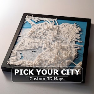 May include: A framed 3D map of a city, rendered in white, set against a blue background. The map is highly detailed, showing buildings and streets. The frame is black, and the text "PICK YOUR CITY" and "Custom 3D Maps" are displayed on the bottom.