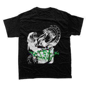 May include: Black t-shirt featuring a white graphic of two anime-style figures with maid headbands and green accents. The design is a stylized illustration. The shirt is made of a soft, comfortable material.
