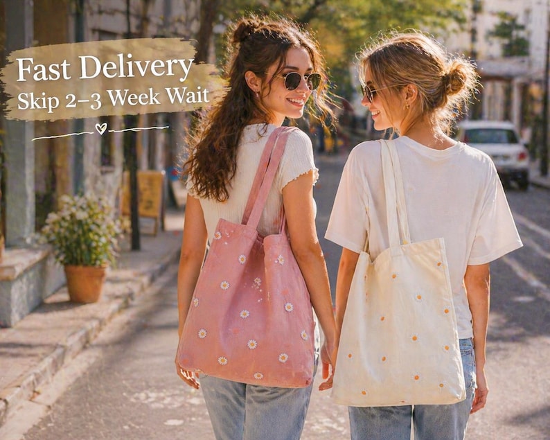 May include: Two women walking down a street, each carrying a tote bag. One bag is pink with white daisy patterns, the other is cream-colored with orange daisy patterns. The text "Fast Delivery Skip 2-3 Week Wait" is visible in the image.