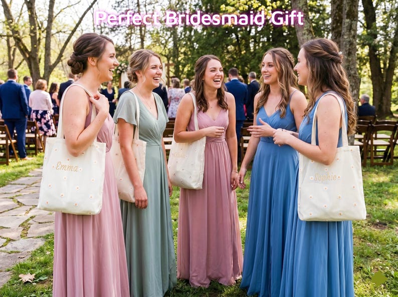 May include: Five women in long, flowing dresses of pink, green, and blue stand together outdoors. Each woman carries a white tote bag with a floral pattern and a name embroidered on it. The text "Perfect Bridesmaid Gift" is at the top.