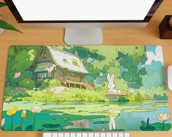 May include: A green and blue mousepad with a cartoon illustration of a small wooden house, a pond with lily pads, and a white rabbit sitting on a log.