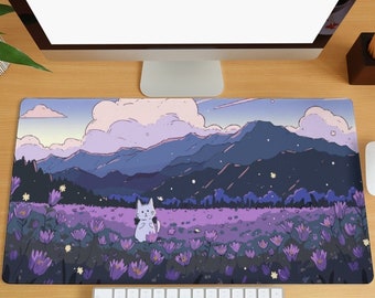 May include: A purple and blue mountain landscape with a white cat in a field of purple flowers. The scene is on a mouse pad with a keyboard and a computer monitor in the background.