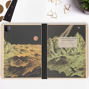 May include: A wood-grain iPad case featuring a vintage-style illustration of a lunar landscape. The case has a black spine and a label that reads "COMPOSITION NOTEBOOK COLLEGE RULED".