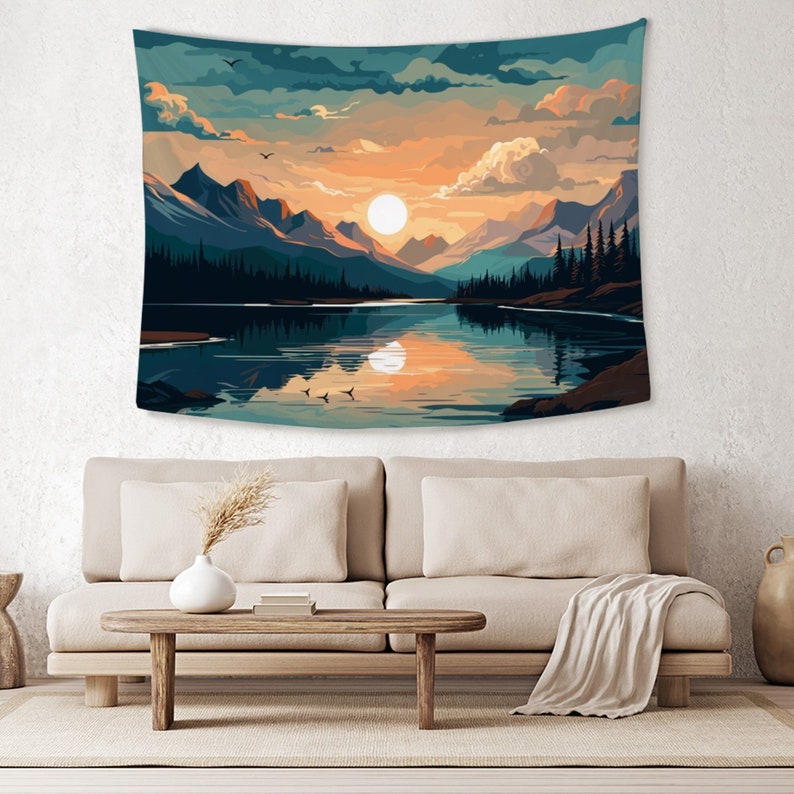 May include: A tapestry featuring a scenic landscape with a lake reflecting a sunset over mountains. The sky is a mix of blue, orange, and pink with fluffy clouds. The lake is a deep blue with a reflection of the sunset. The mountains are a dark green and brown.