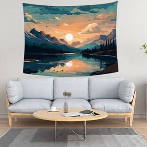 May include: A tapestry featuring a scenic landscape with a lake reflecting a sunset sky. The lake is surrounded by mountains and trees, with a large, bright sun visible in the sky. The tapestry is a vibrant and colorful depiction of nature.
