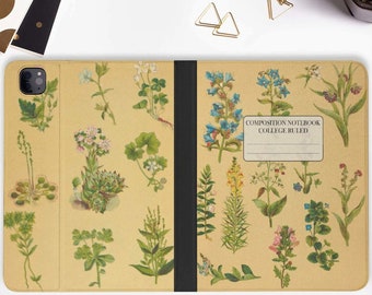 May include: A brown leather iPad case with a floral design. The case has a black spine and a flap that closes with a magnetic closure. The front of the case has a vintage botanical illustration of flowers and plants. The back of the case has the text "COMPOSITION NOTEBOOK COLLEGE RULED".